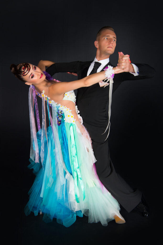 Couple gracefully performing the Viennese Waltz on the dance floor.