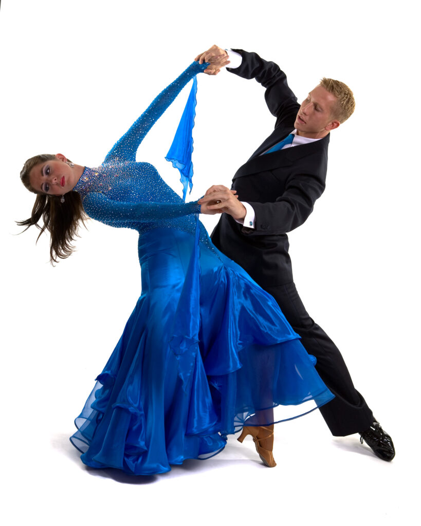 Elegant couple dancing foxtrot in formal attire during a ballroom event