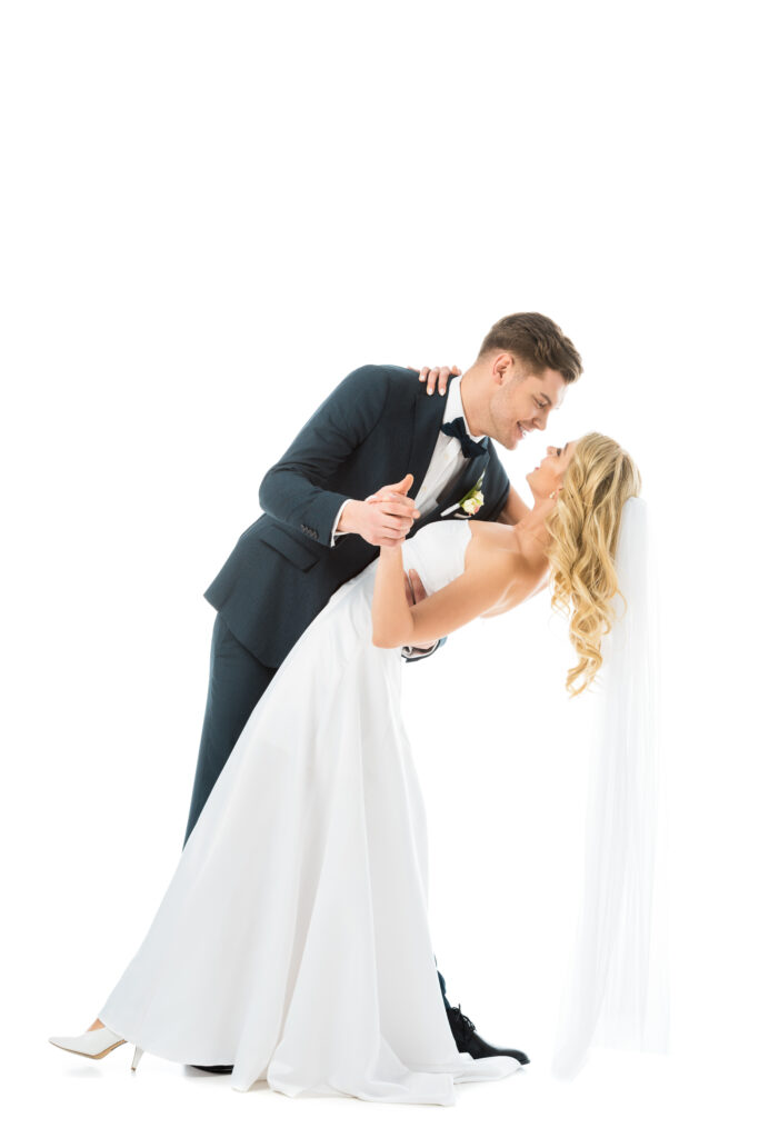 Groom lifting bride in a fun, choreographed dance moment