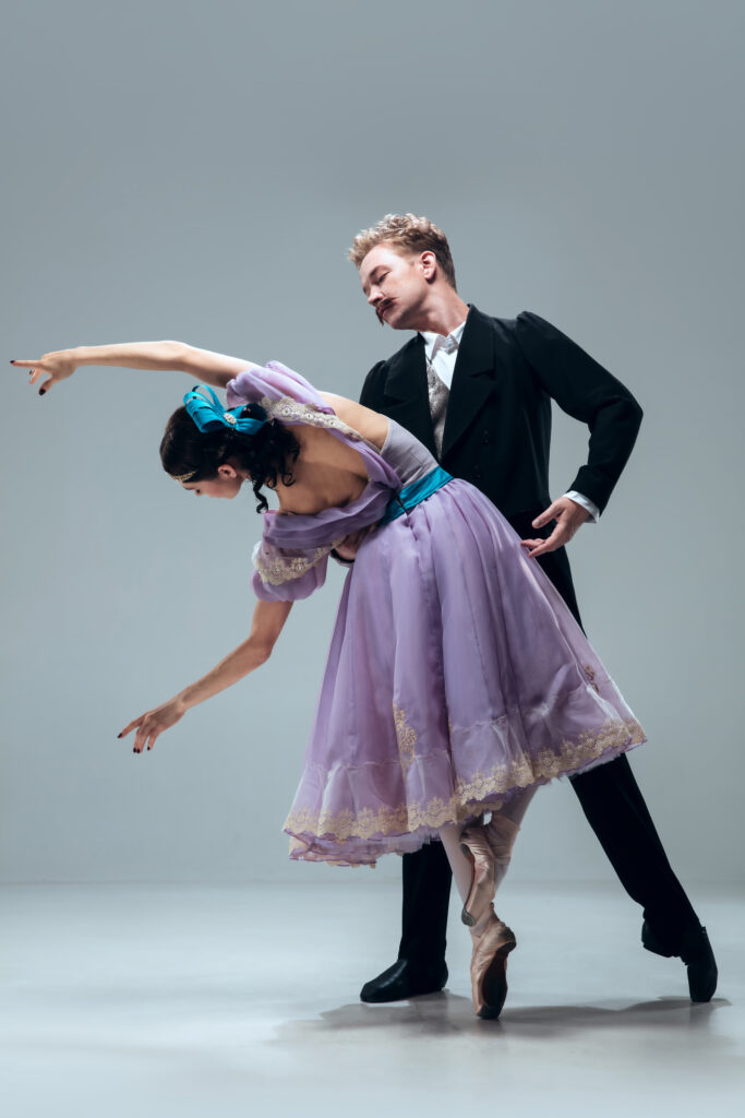 Elegant couple dancing the traditional Viennese Waltz at a ballroom event.