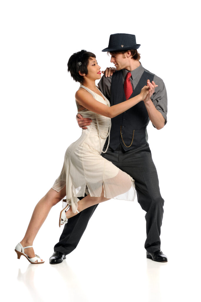 Tango dance instructor showing sharp ballroom tango move with precision and flair