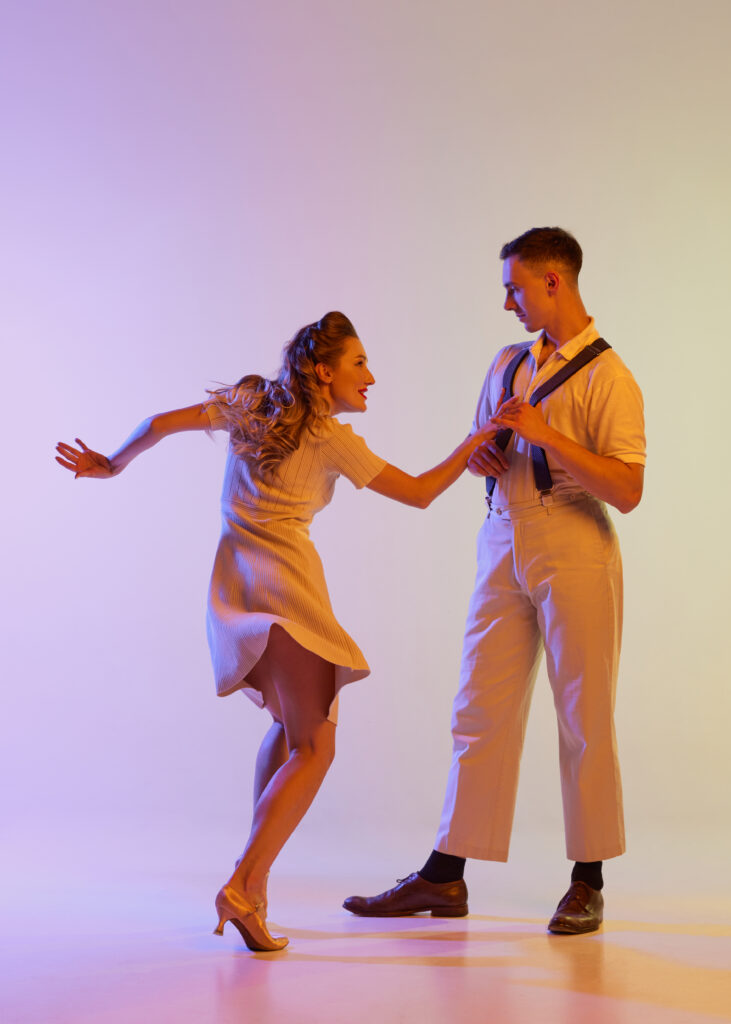 Happy students enjoying upbeat Jive dance class for beginners