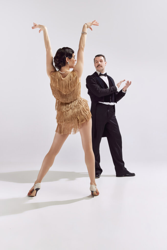 Couple dancing together in a cozy studio setting.